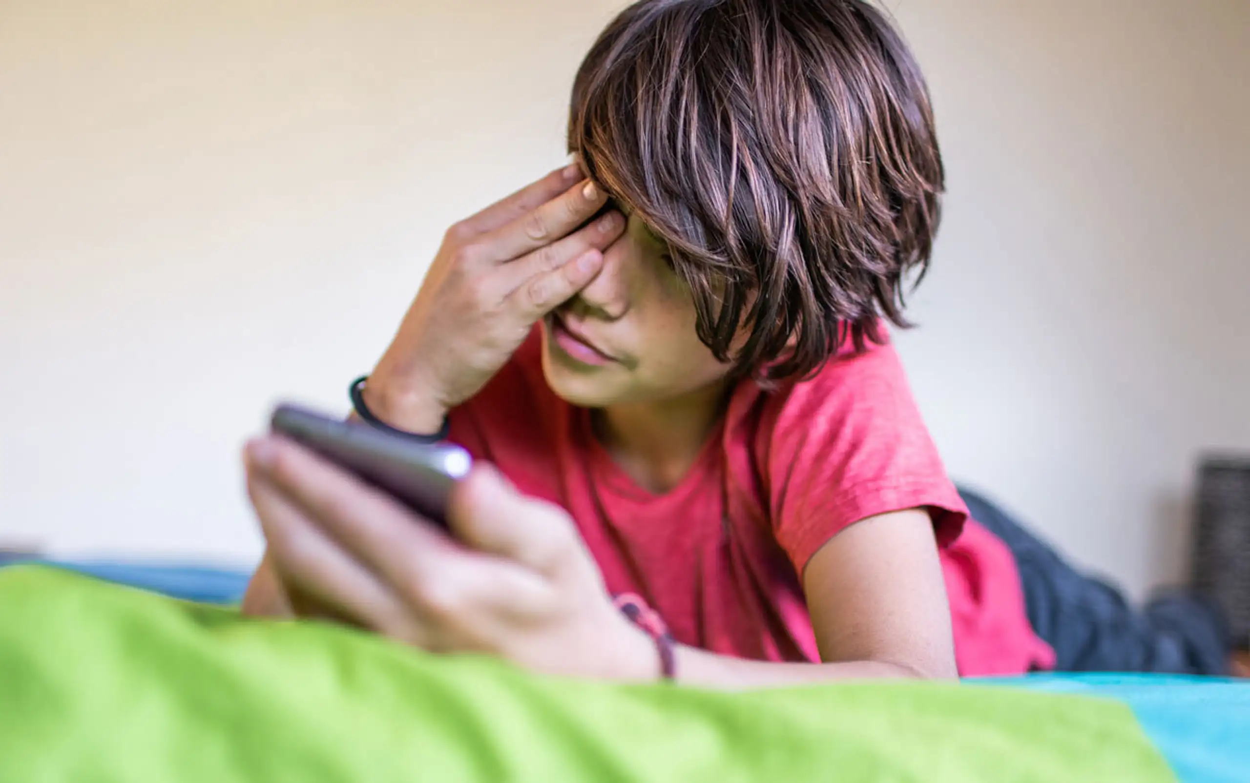 Teen Rubs Eye From Screentime